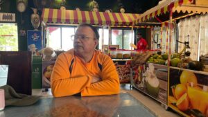 Writer Dr Viranchi Achary sitting in a Dhaba for food 